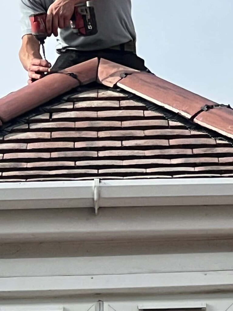 This is a photo of one of the operatives of Waterlooville Roofing Repairs installing new ridge tiles